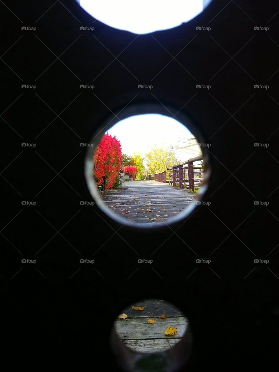 View of the Inner Harbor Creek walkway through holes in a metal post.