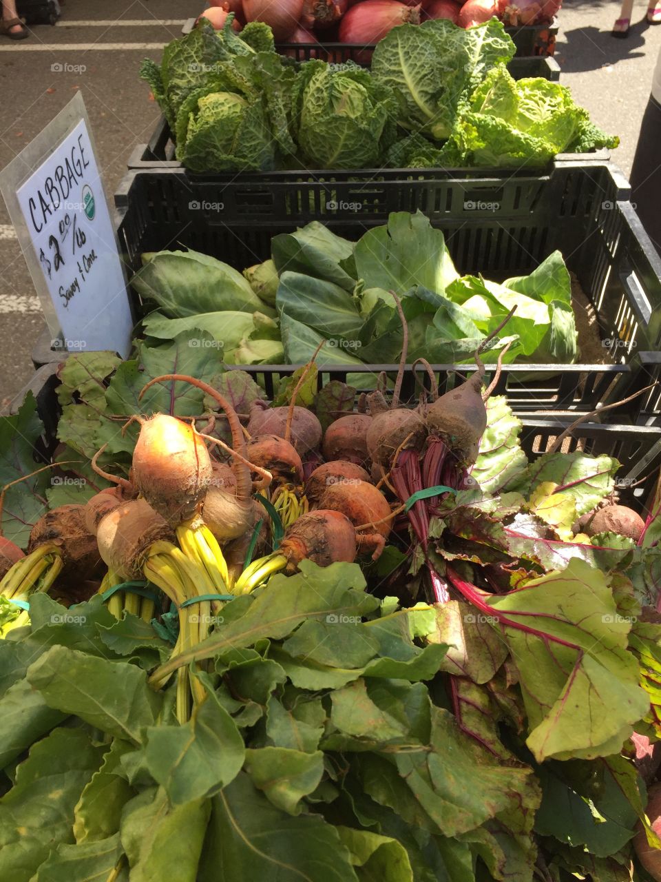 Greens and root vegetables in farmers market.  Red and orange beets. Eat your vegees.