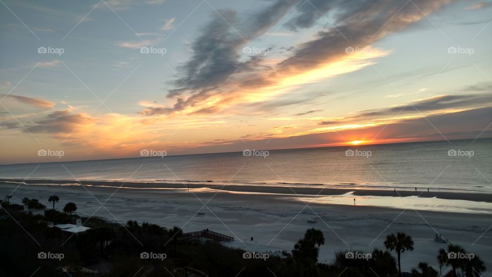 Wideshot photo of a sunrise on a beach