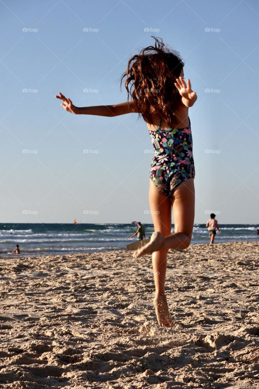 Girl dancing on the beach 