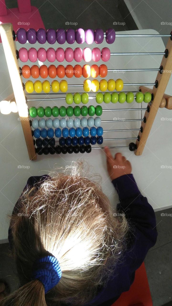 A child plays by Colored pellet setup.