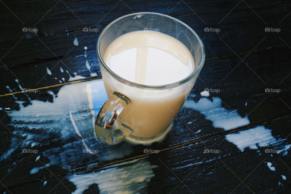 cup of milk on a black background