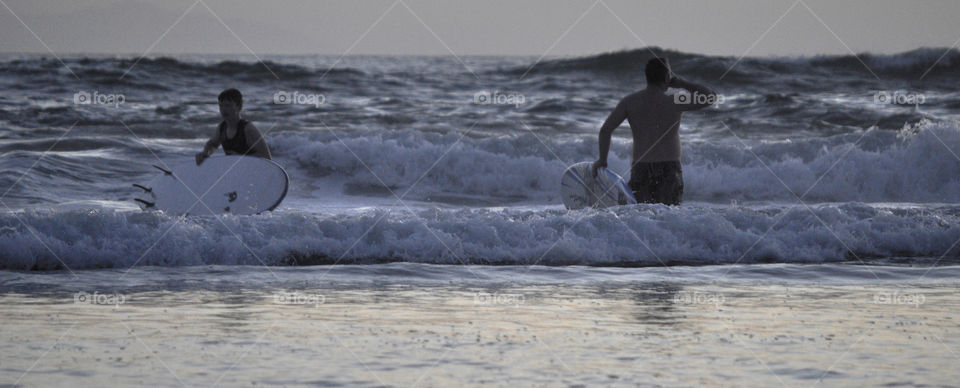 Surfers scoping out the waves