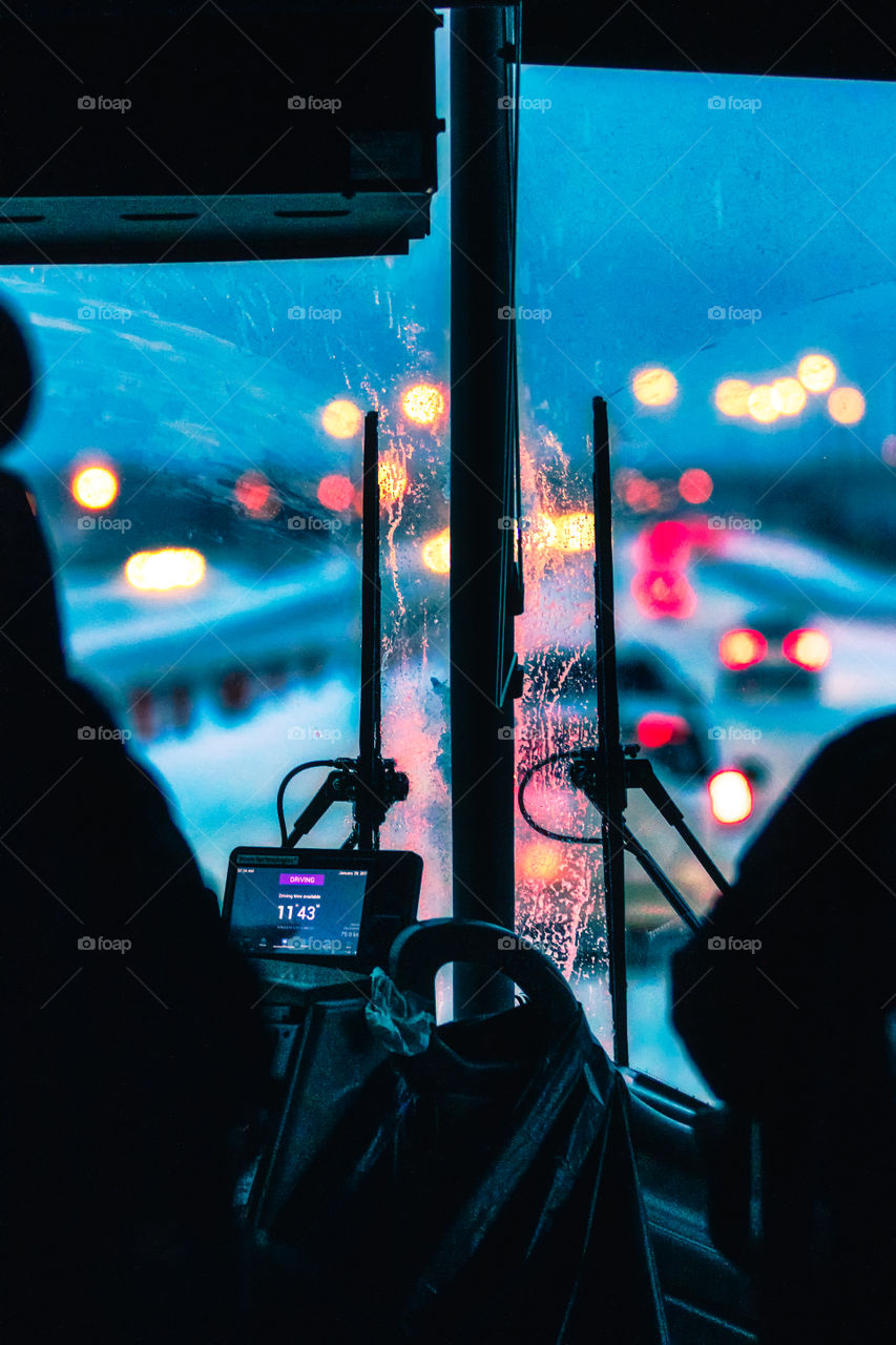 View from inside a public bus on a cold snowy winter evening. Blue hour creating cool tones.