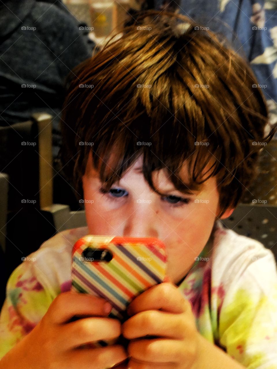 Young Boy Using A Smartphone
