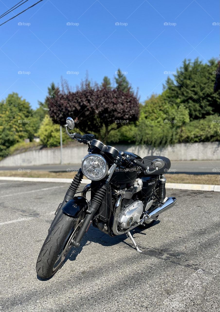 Black motorbike at the empty parking lot 