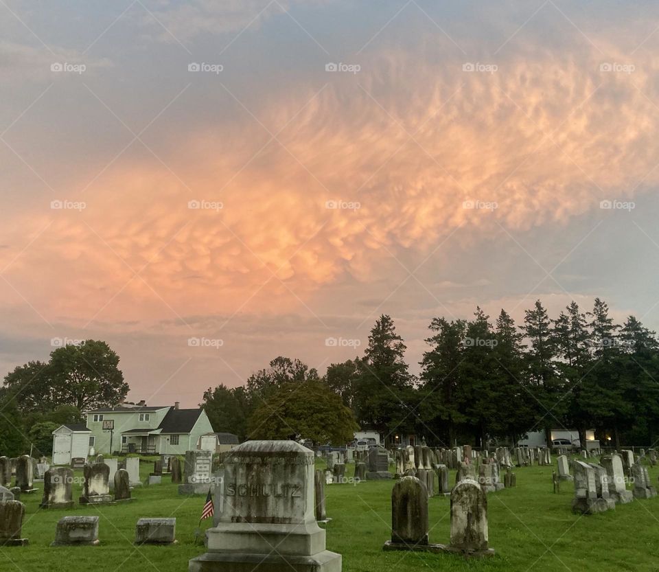 Sunset illuminates clouds above cemetery in Strasburg,PA. 