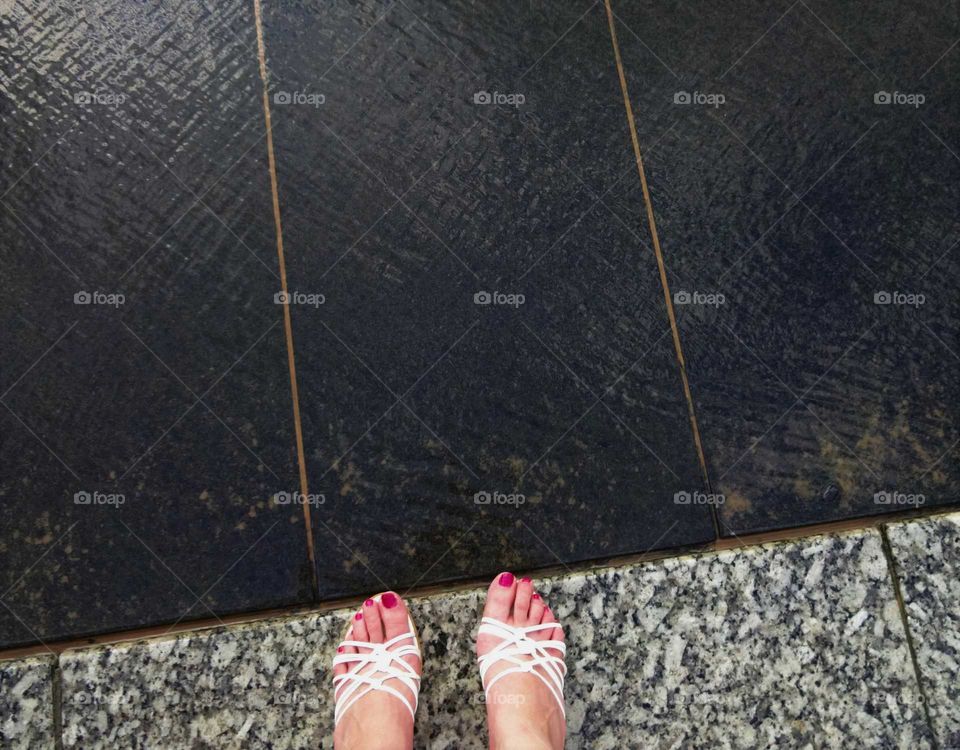 close up of woman's feet by fountain at Old Market Square in Nottingham, England