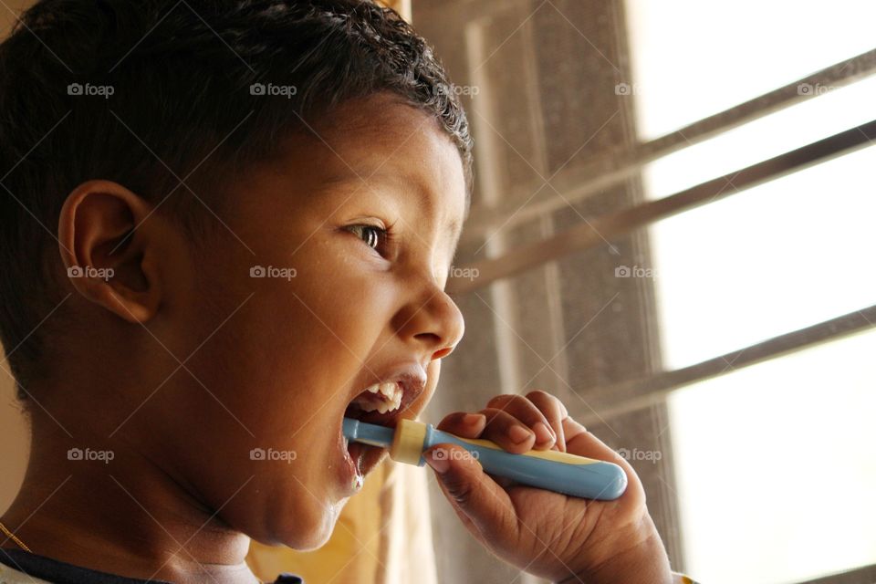 little baby brushing his teeth