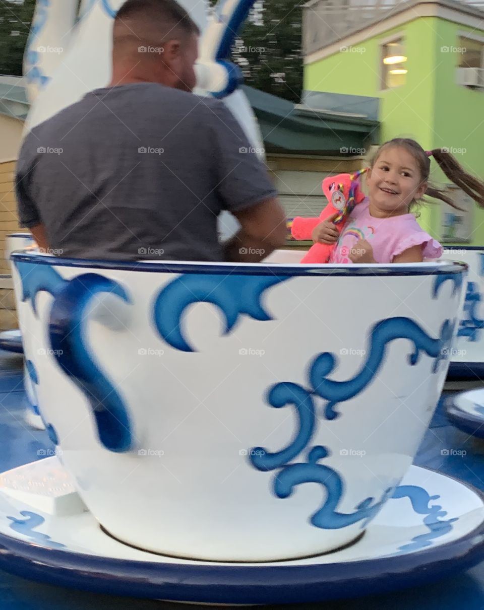 Enjoying The Tea Cup Ride At The Carnival 