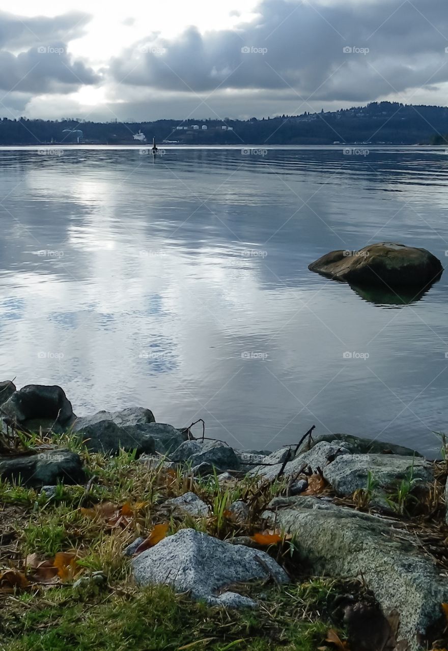 Calm ocean bay in Belcarra BC near Vancouver. The water is like glass, like a millpond, early evening. 