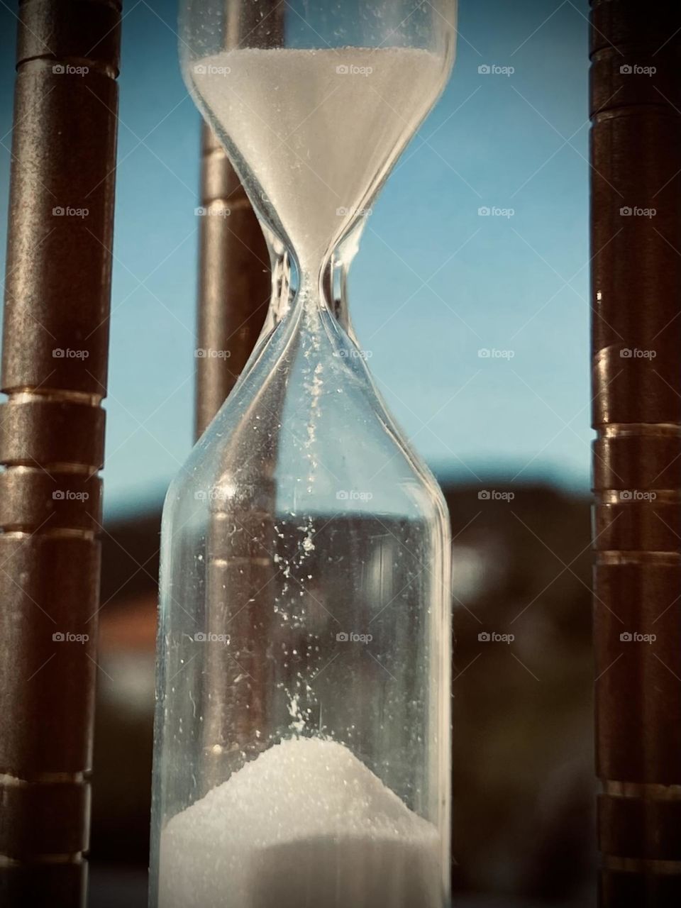 The slow passing of time like sands in an hourglass.