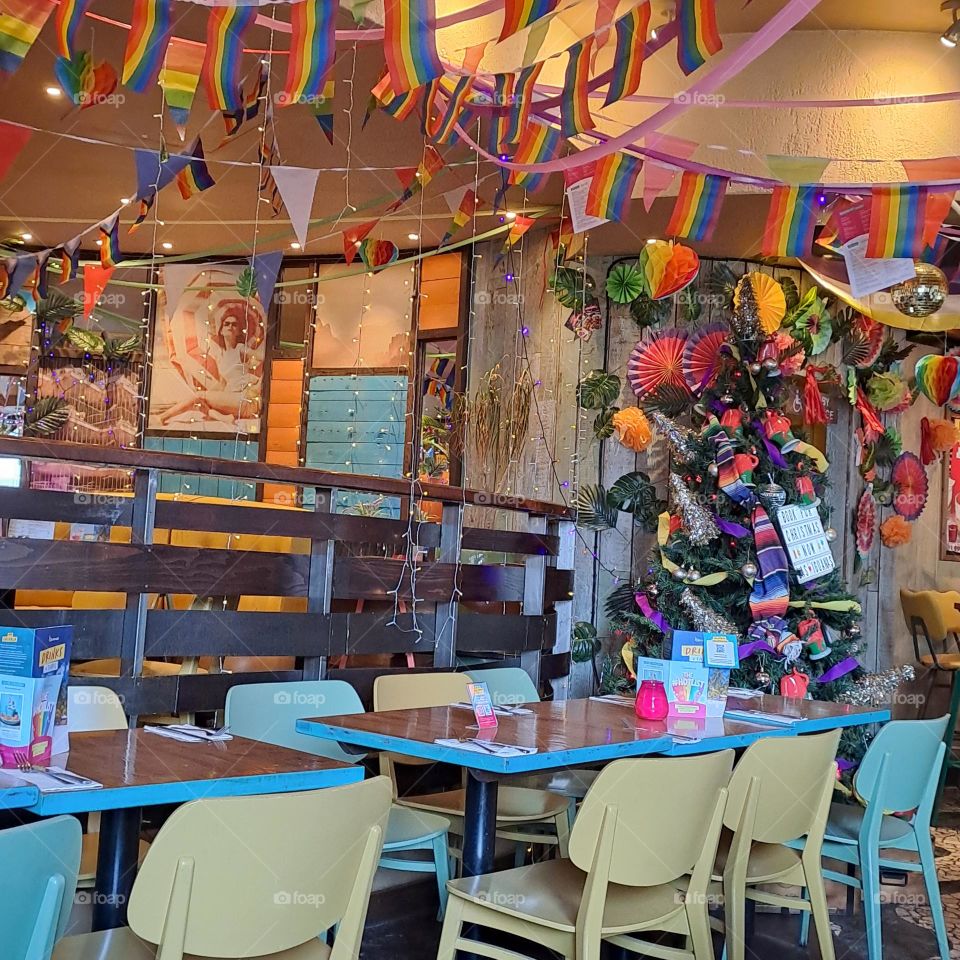 spanish fiesta style decorated restaurant in Brighton U.K colourful flags chairs tabkes dining