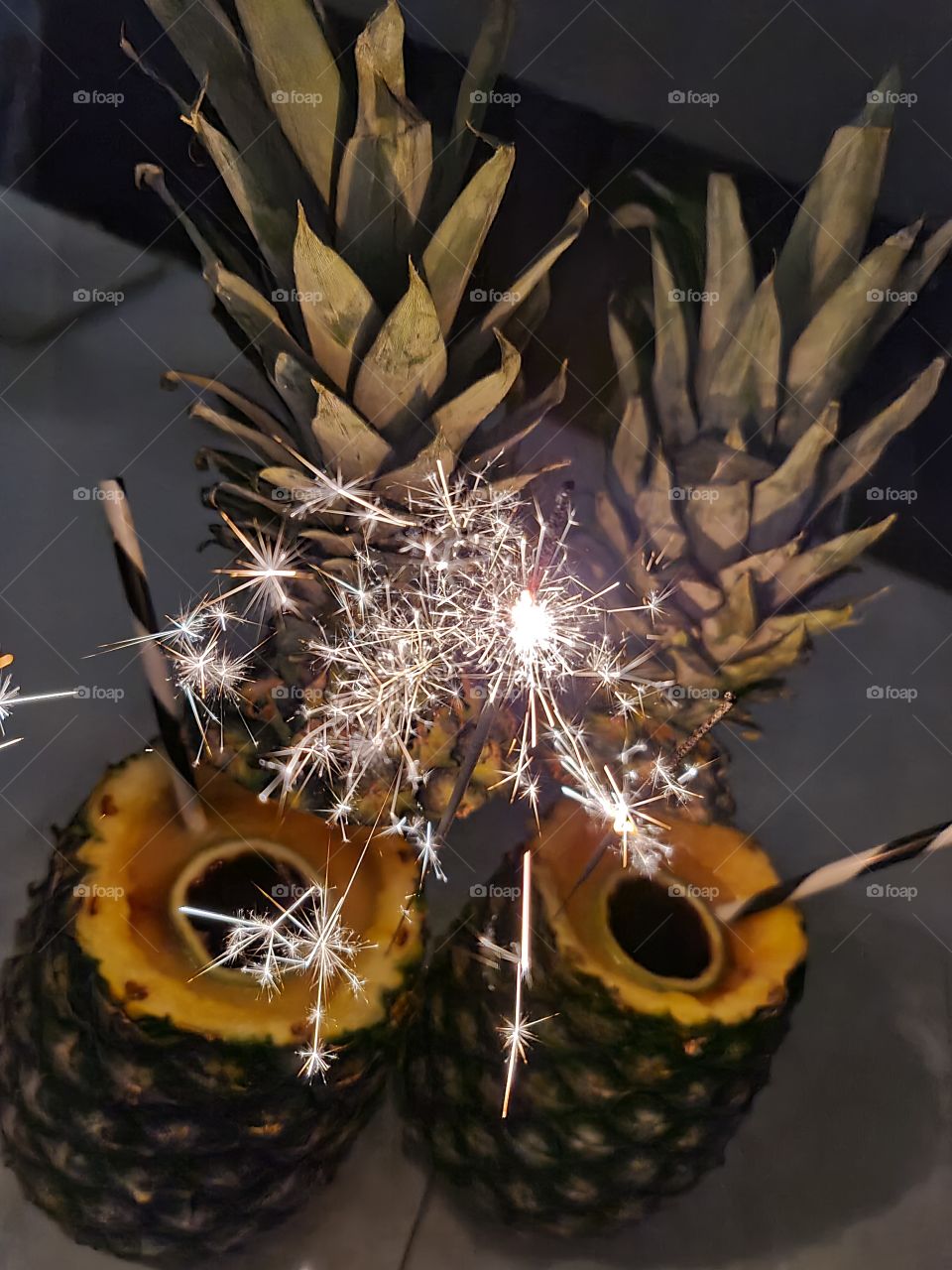 Festive Pineaple coctail with Jegermaister for Birthday party celebration.Tropical party theme. Lights decoration. Tasty alcoholic coctail made with pineaple fruit blended and mixed with mango juice, shot cups made of limr.