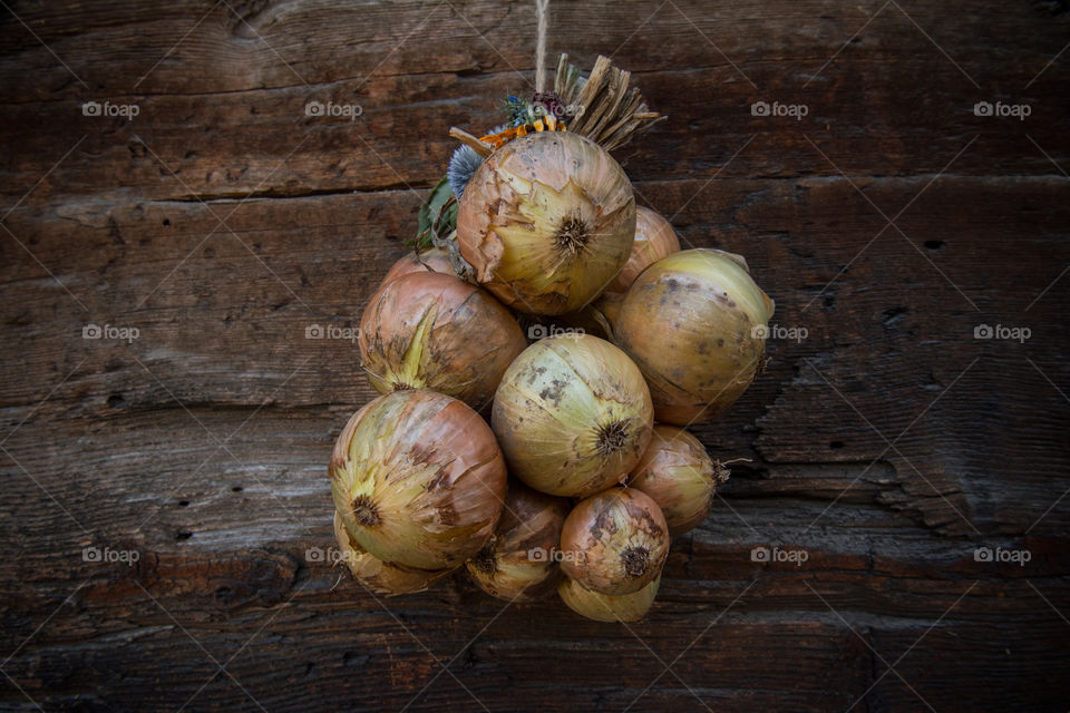 onion bulbs hanging in front of a barn
