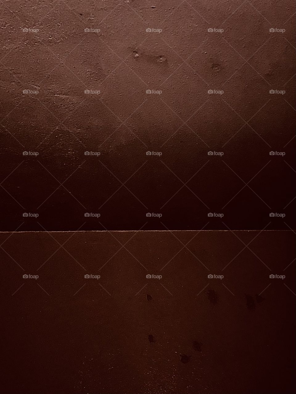 An abstract photograph of two rectangular shapes together, with slightly different hues. The top shape shows a minor gradation of values.