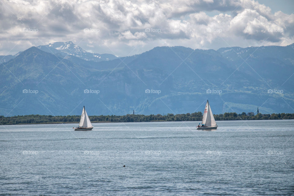 Sailboat sailing on sea against sky