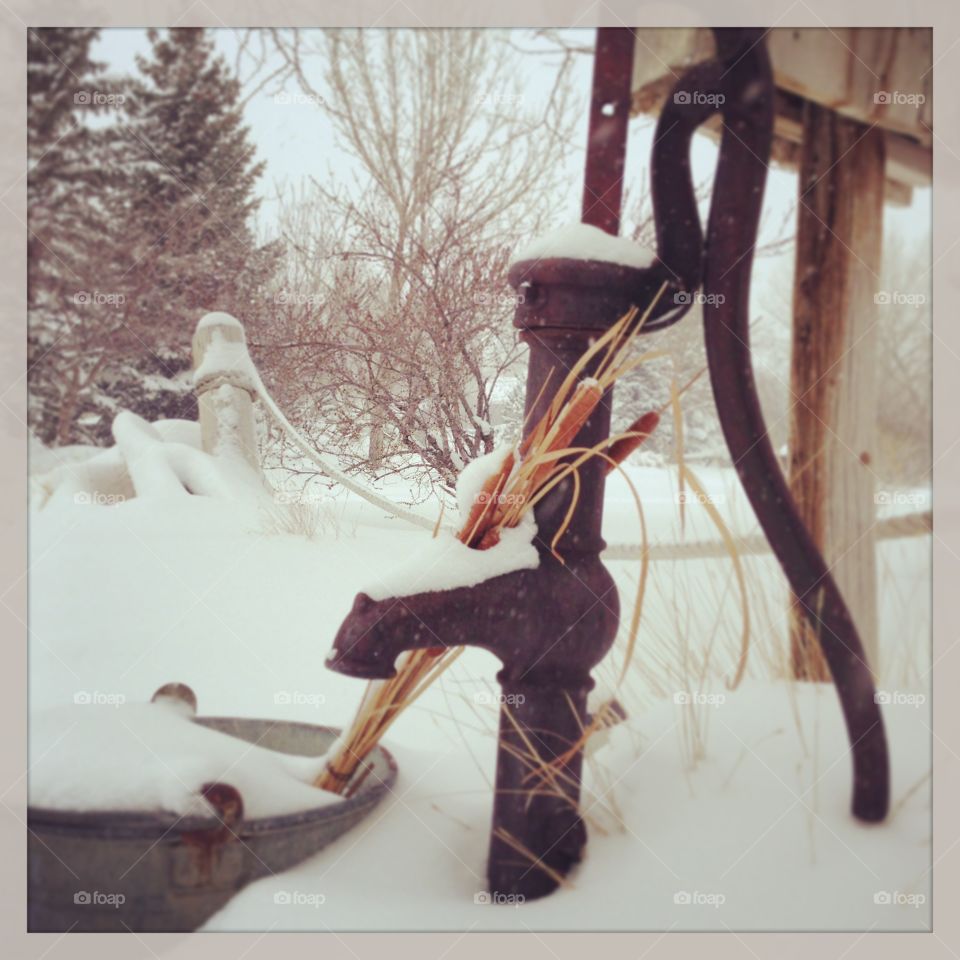 Winter Water Pump. Antique water pump in a snowy scene in Wyoming 