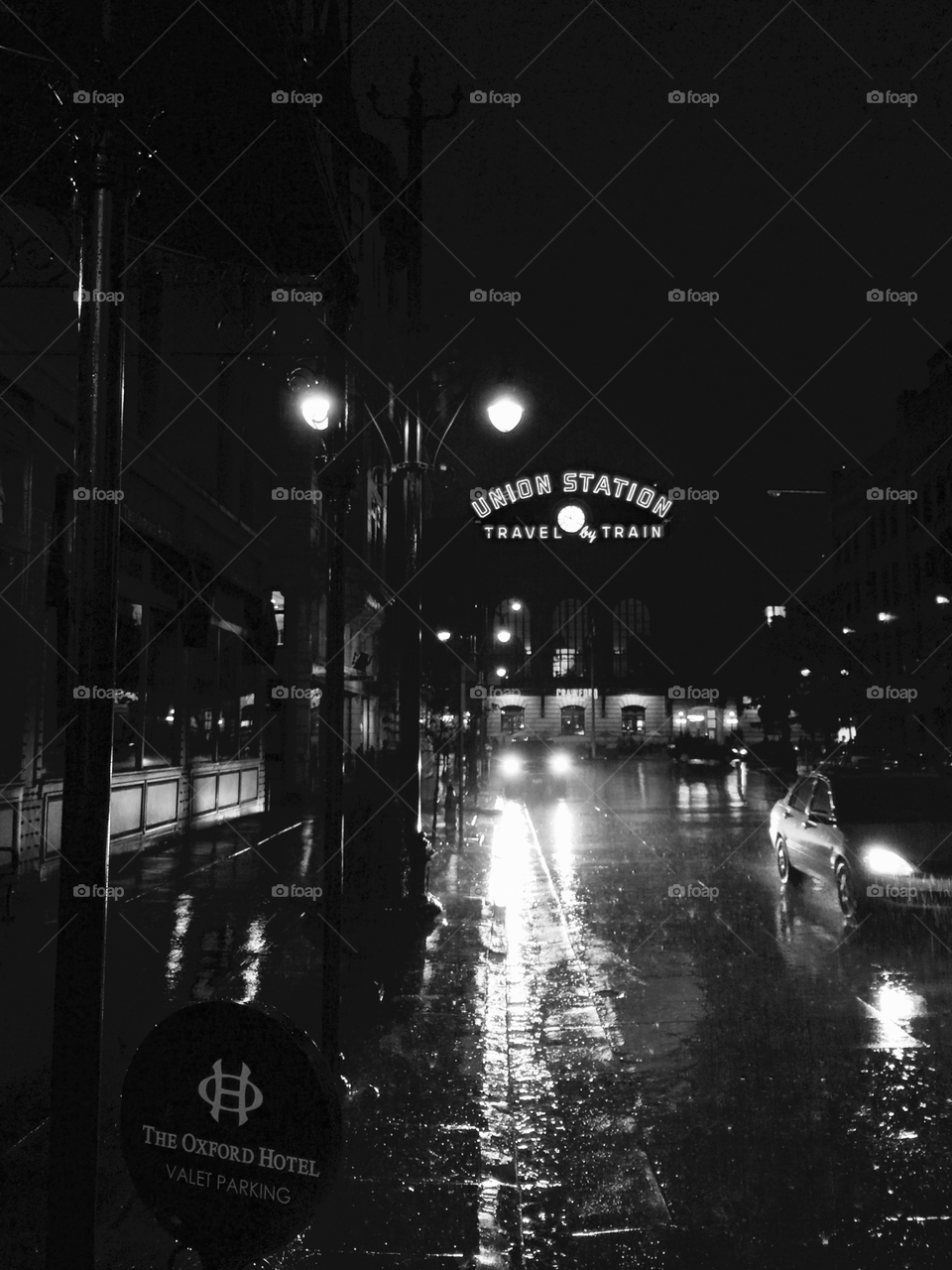 TRAVEL by TRAIN Even in the Rain . Rainy night in front of Union Station in Downtown Denver, Colorado.