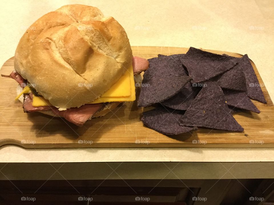Roast beef sandwich and blue chips.