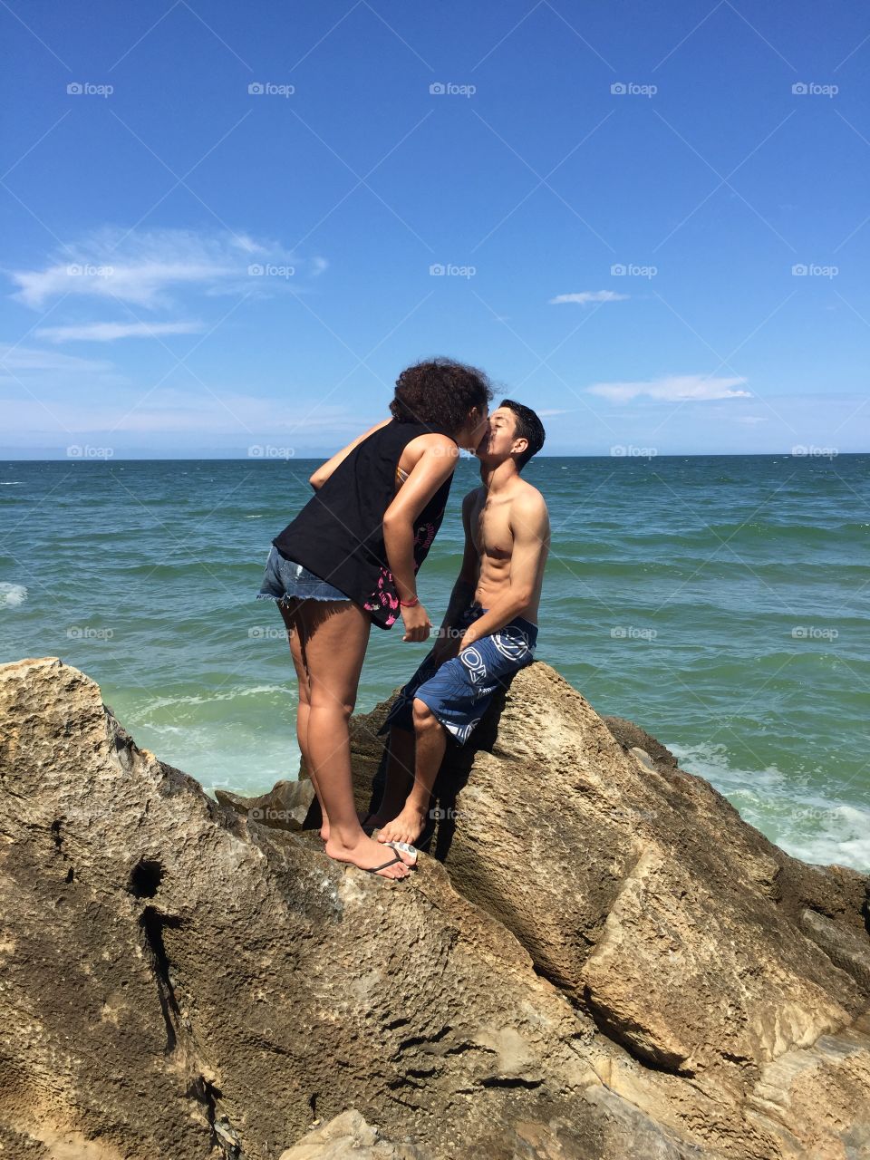 Cute couple kissing near seaside