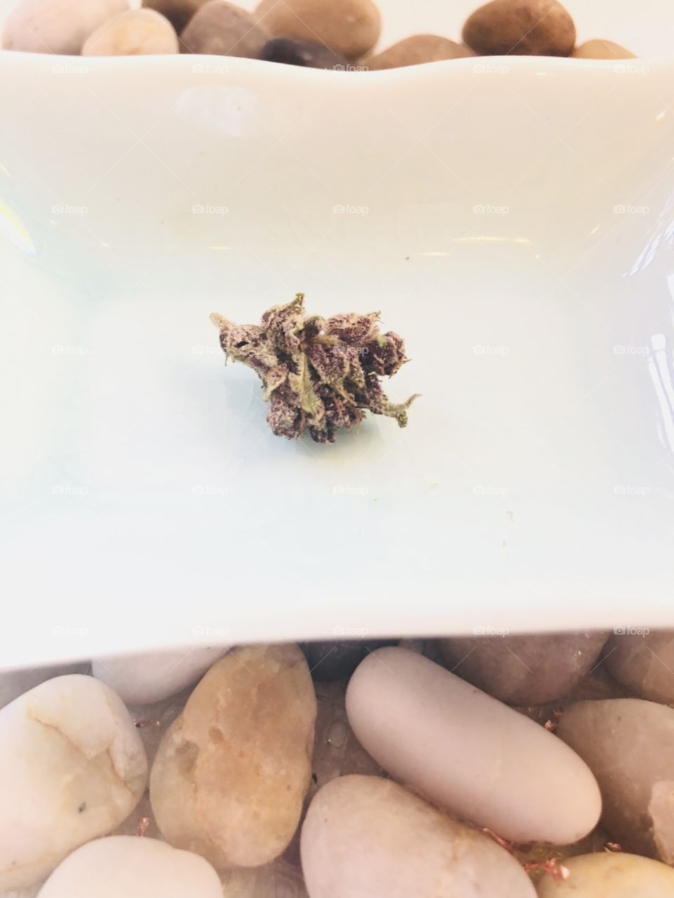 Still life Small bud marijuana cannabis in ceramic dish with stones 