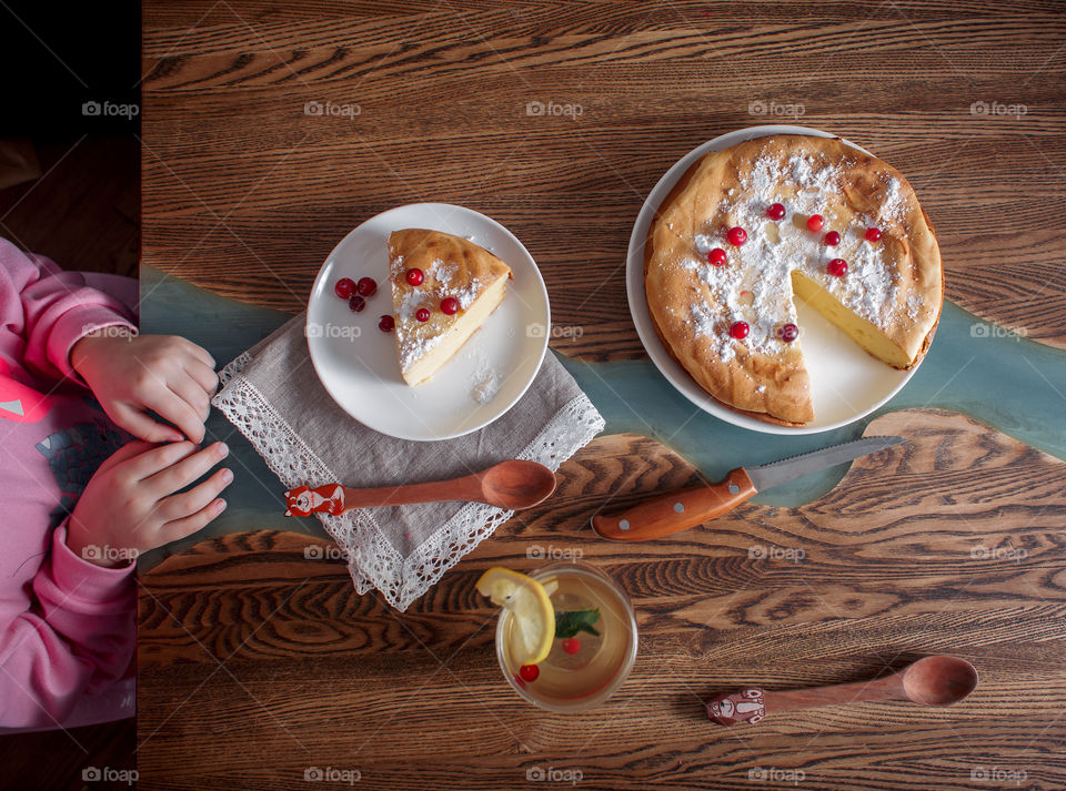 Children breakfast with cheesecake. Hands, detail