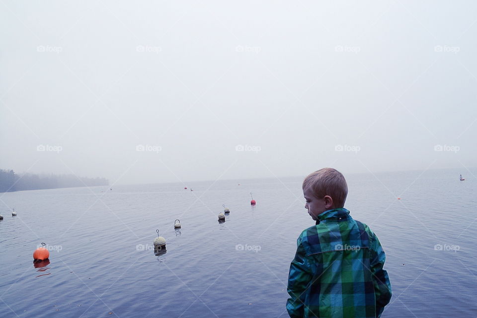 Boy at the misty lake