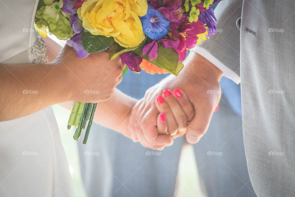 Couple holding hands during wedding ceremony