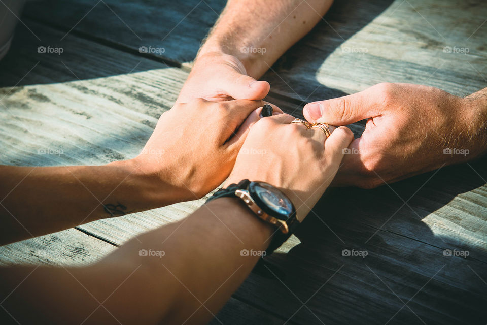 Couple holding hands on table