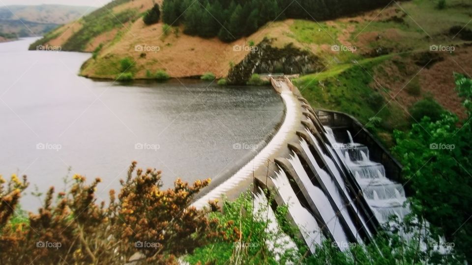 Mid Wales countryside,  Clywedog Dam flowing in the midst of green fields