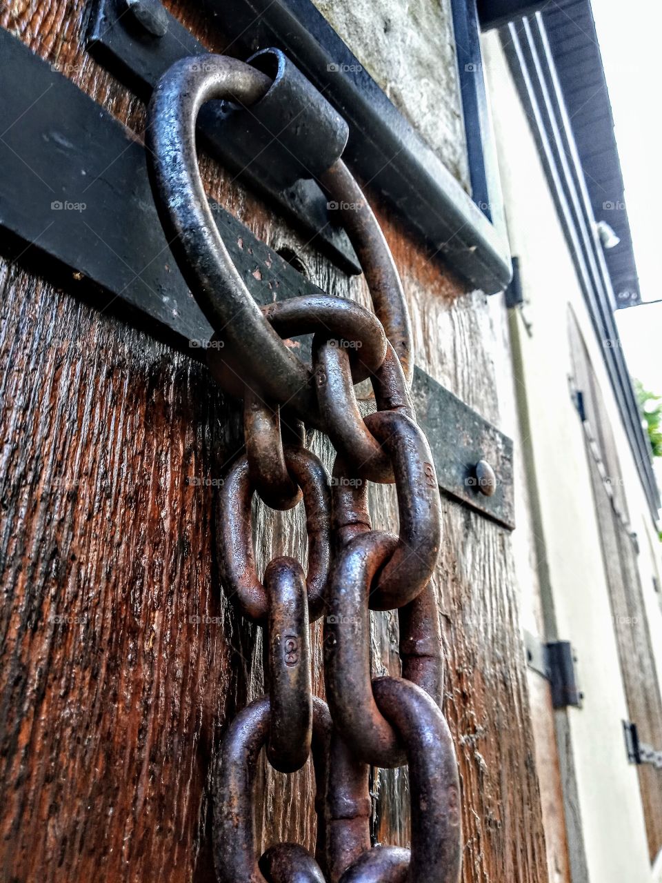 iron chain on old wooden door