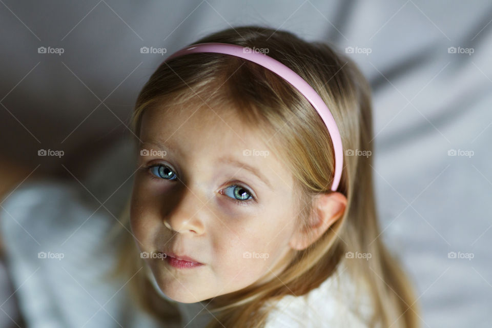 Portrait of cute little girl with blonde hair 