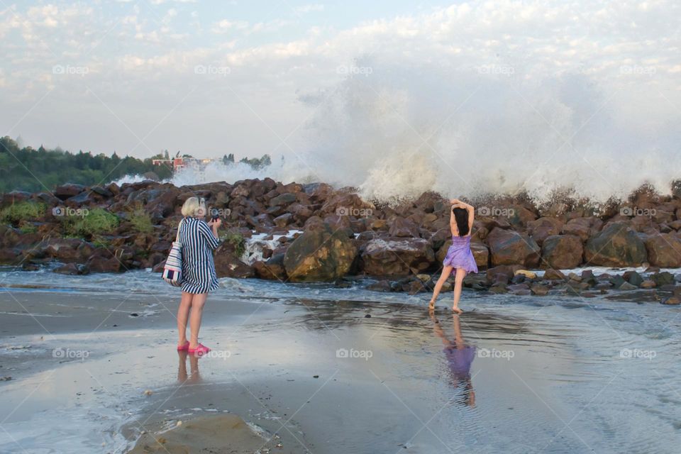 Woman Recording a Video on Stormy Sea