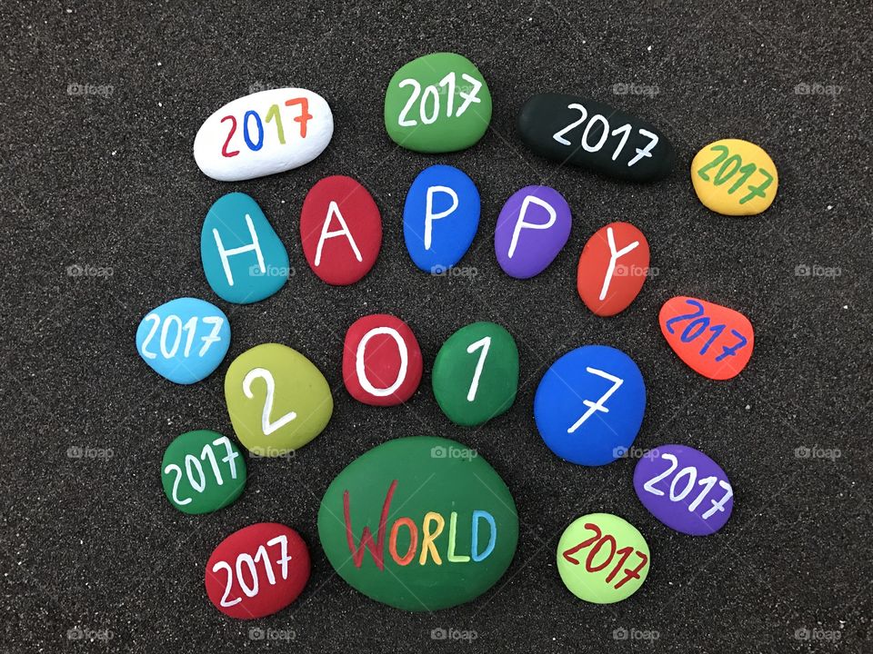 Happy 2017 message with many colored stones 
