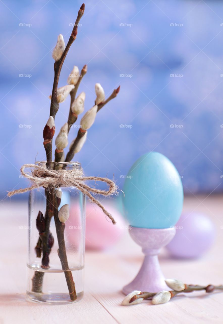 Easter eggs and willow branches in a vase