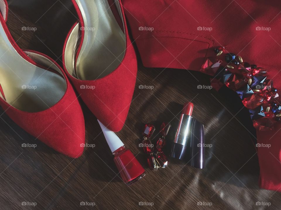 The red high heels, red lipstick, red nail polish, red dress, and red earrings.