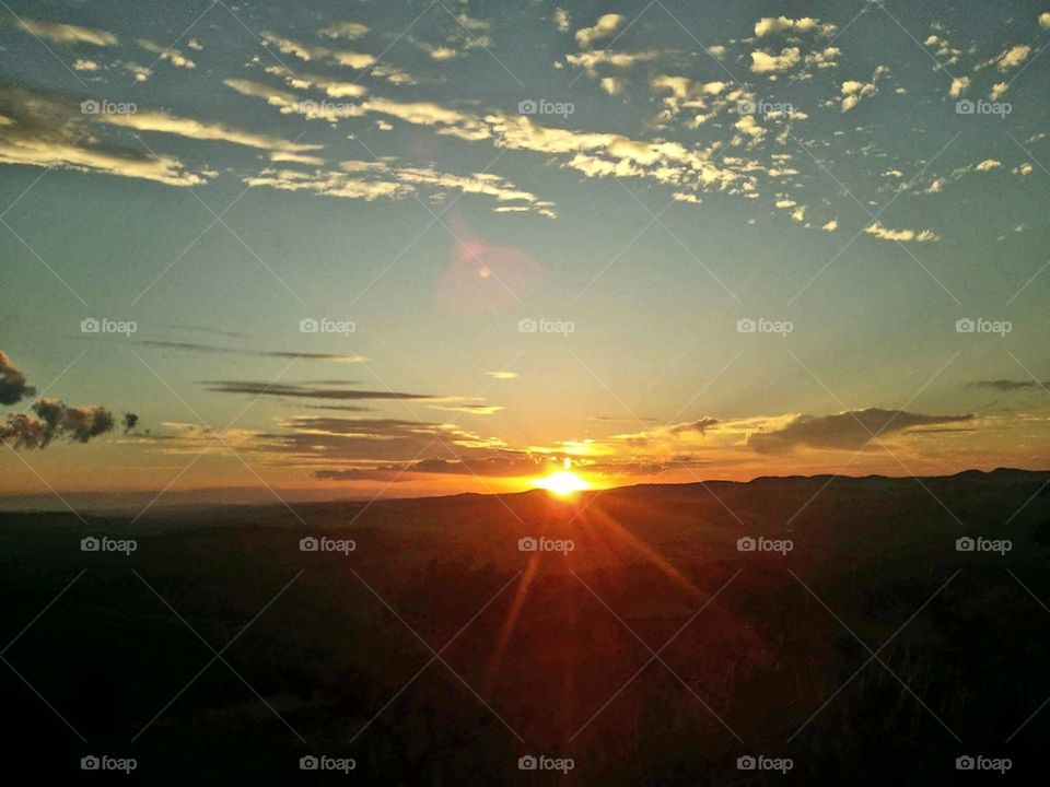 Sun rising over mountains