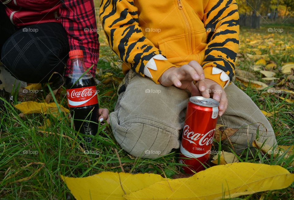 coca cola in hand children, drinking coca cola outdoor