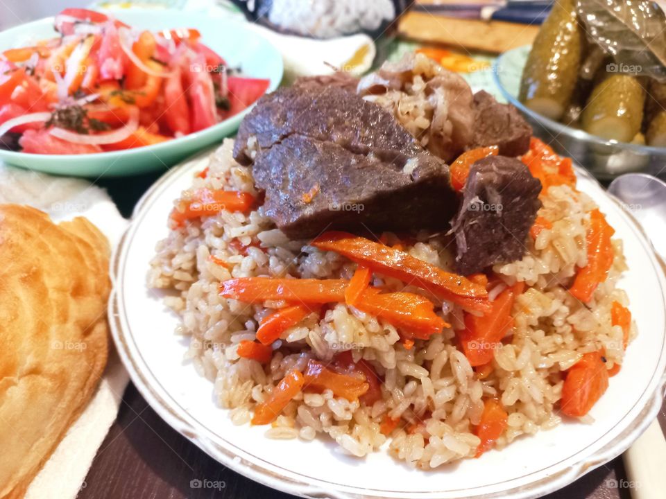 today for lunch we had pilaf with meat, salad with tomatoes, pickled cucumbers and flatbread, an Uzbek national dish.