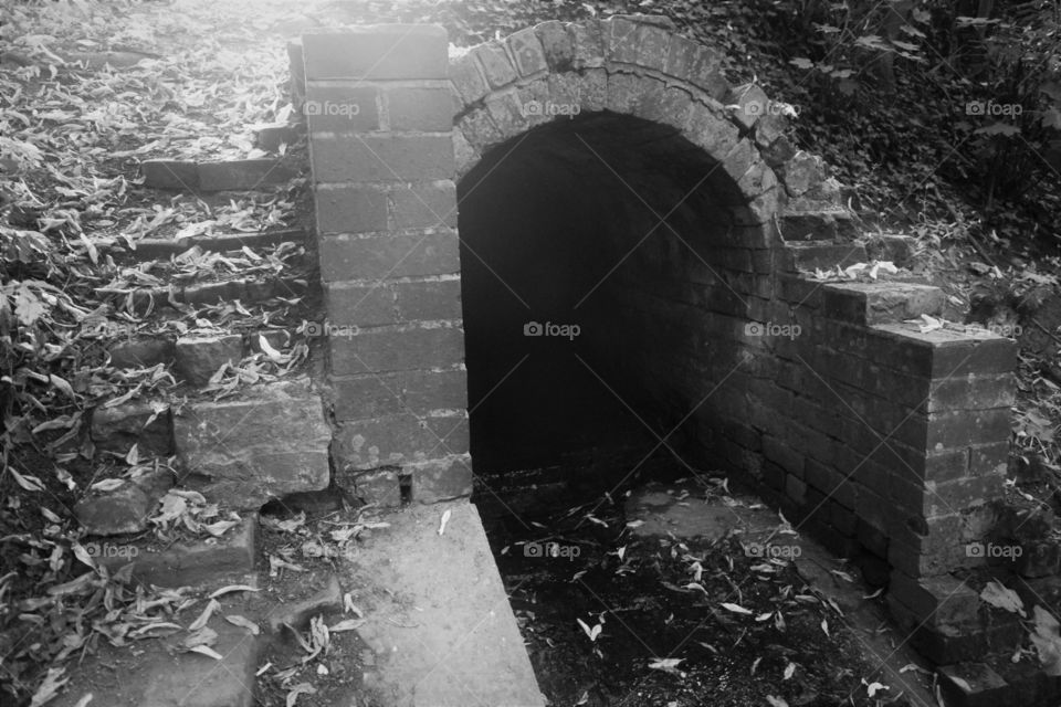 Remains of an old sewer in black and white