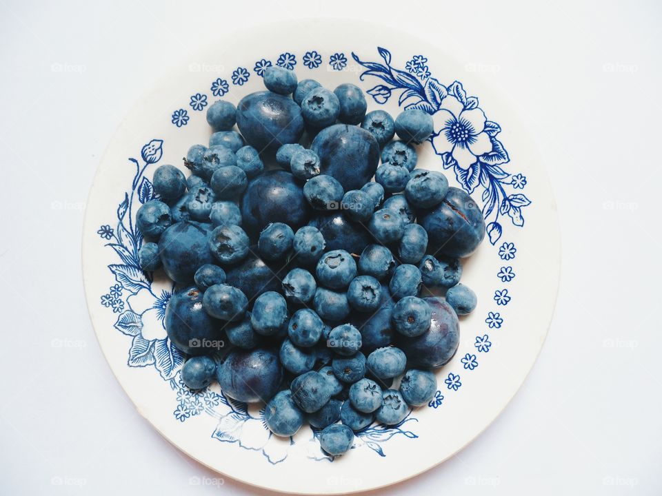 blueberries and plums on a plate