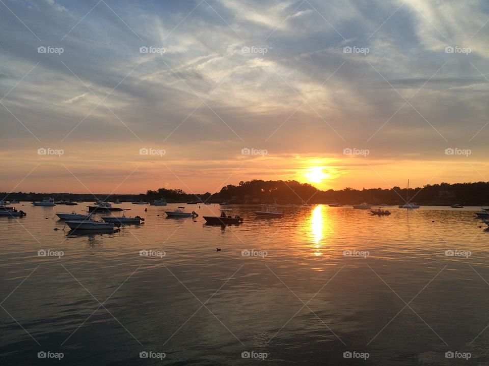 Boats in idyllic lake during sunset
