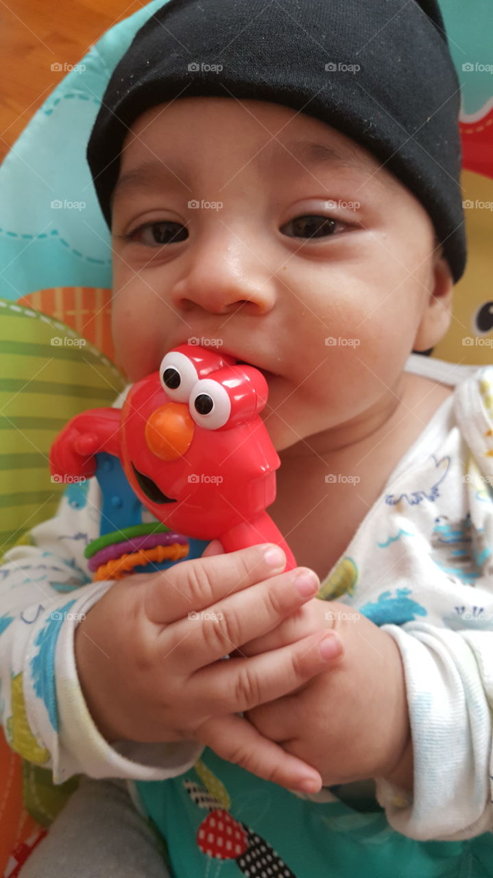 play time for little baby boy with baby rattle