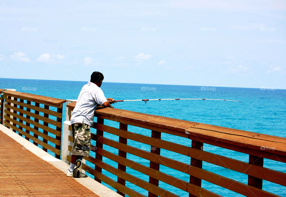 jupiter florida man fishing pier by refocusphoto