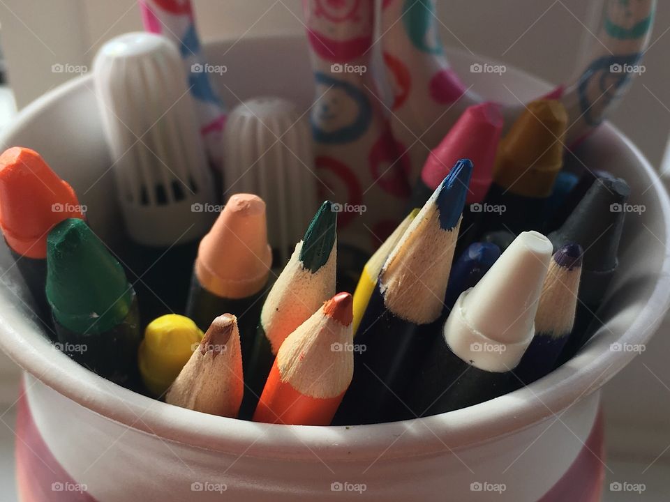 Crayons, coloured pencils,markers and scissors in ceramic pottery. art supplies 