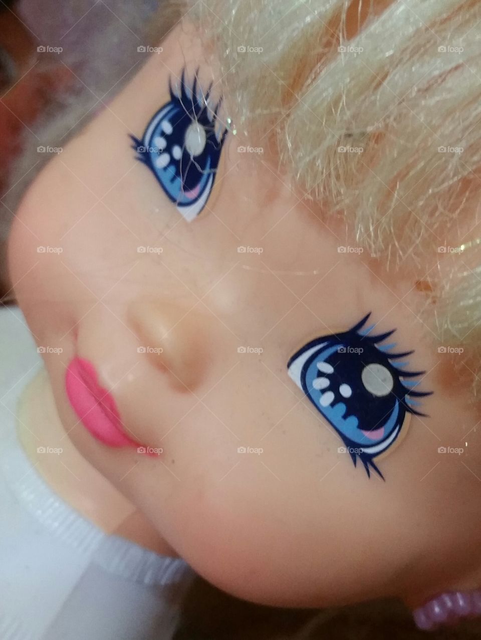 Closeup of a blue eyed doll face
