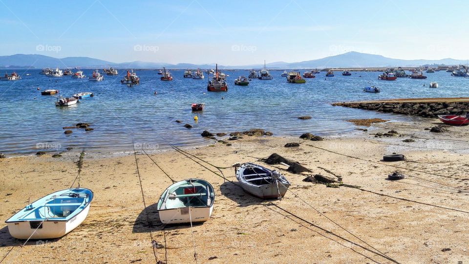 grounded fishing boats on the beach of Puerto de Xufre. Galicia, Spain.