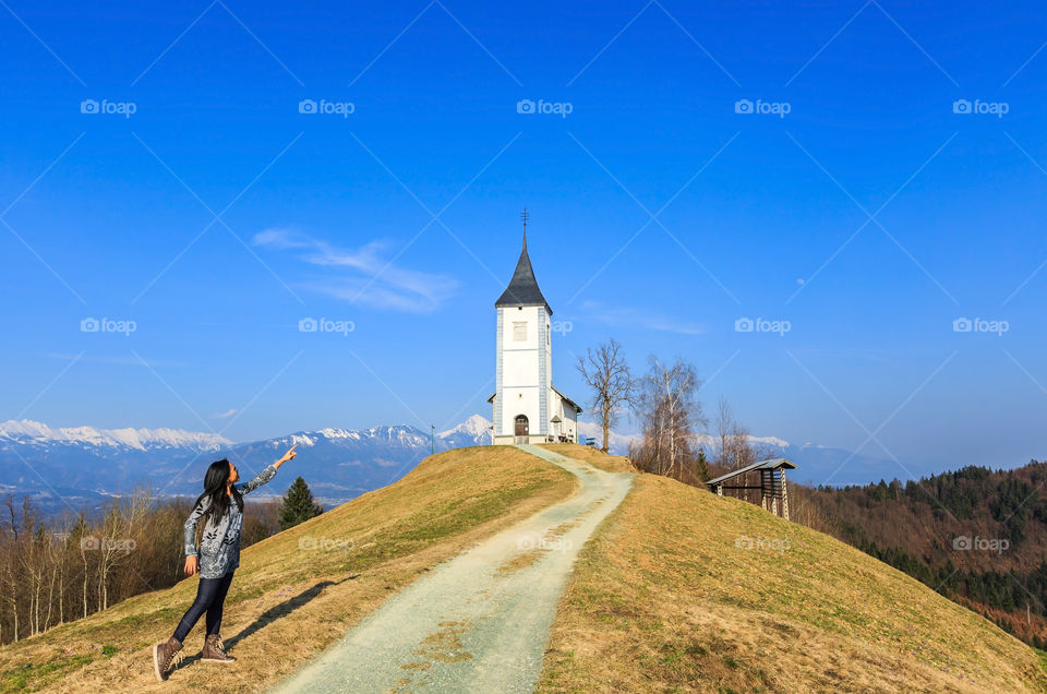 Woman pointing toward the church