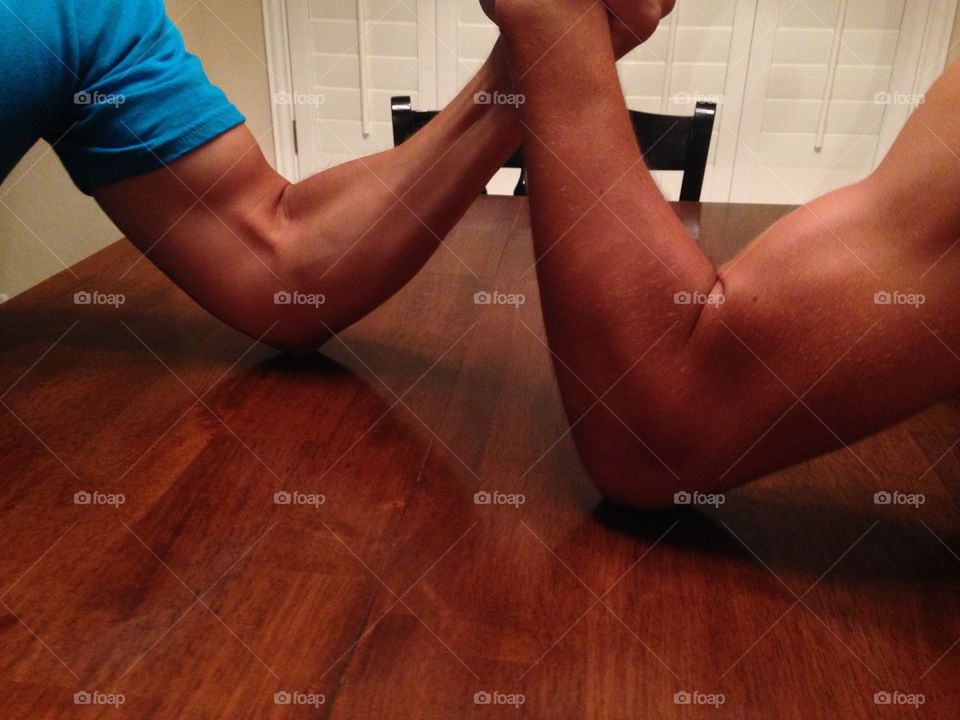 Male bonding . Dad and son arm wrestling